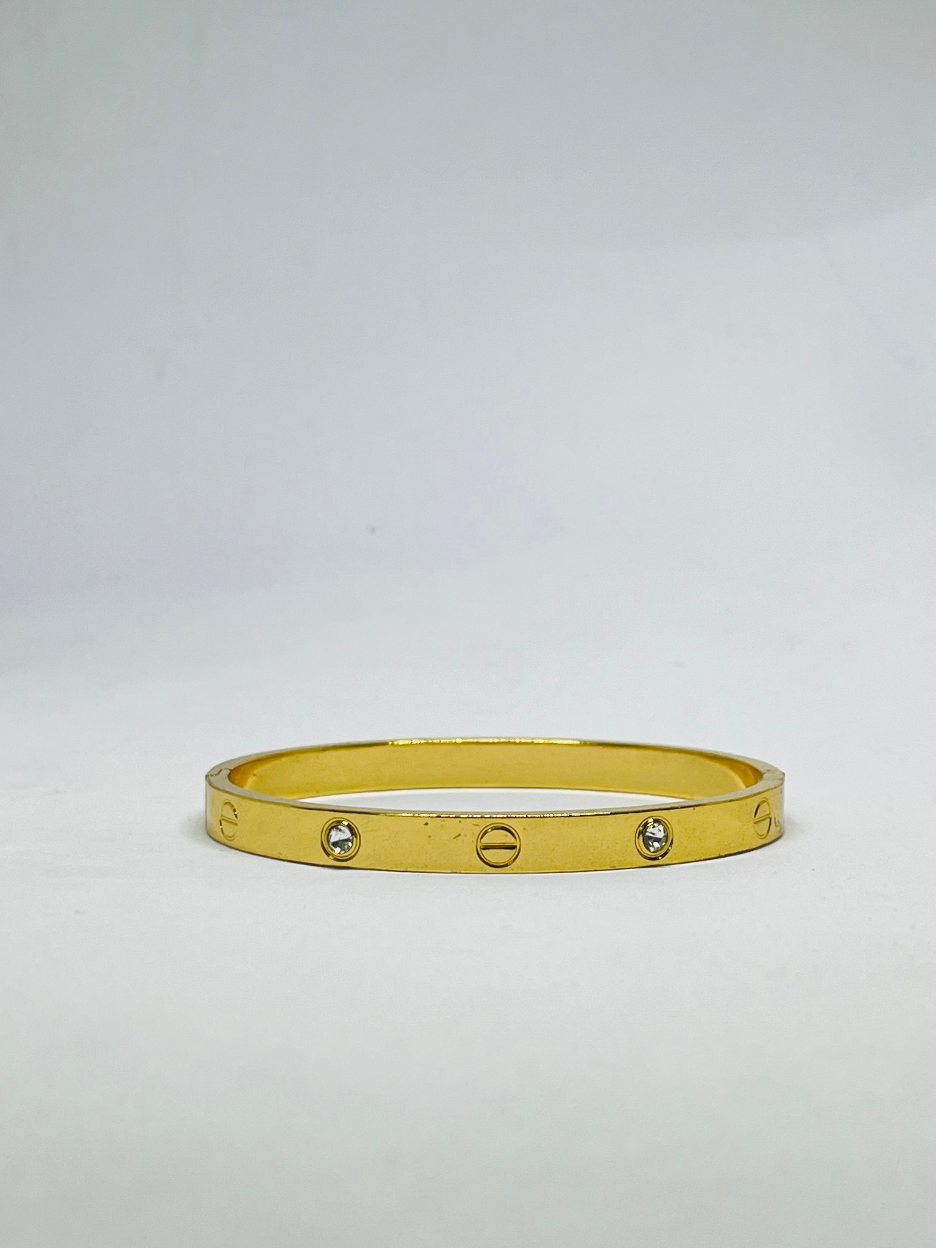 Radiant Gold-Tone Screw Motif Bracelet with Sparkling Stones