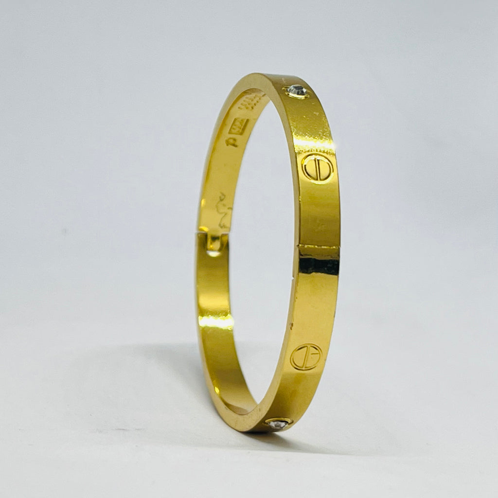 Radiant Gold-Tone Screw Motif Bracelet with Sparkling Stones