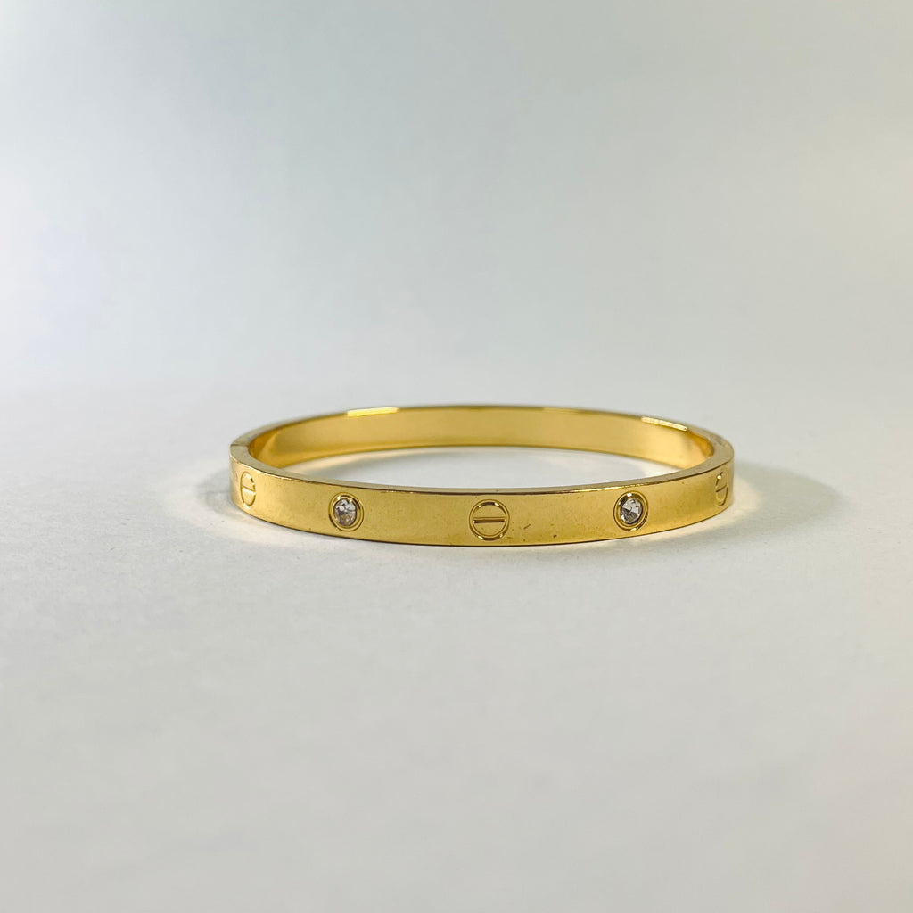 Radiant Gold-Tone Screw Motif Bracelet with Sparkling Stones