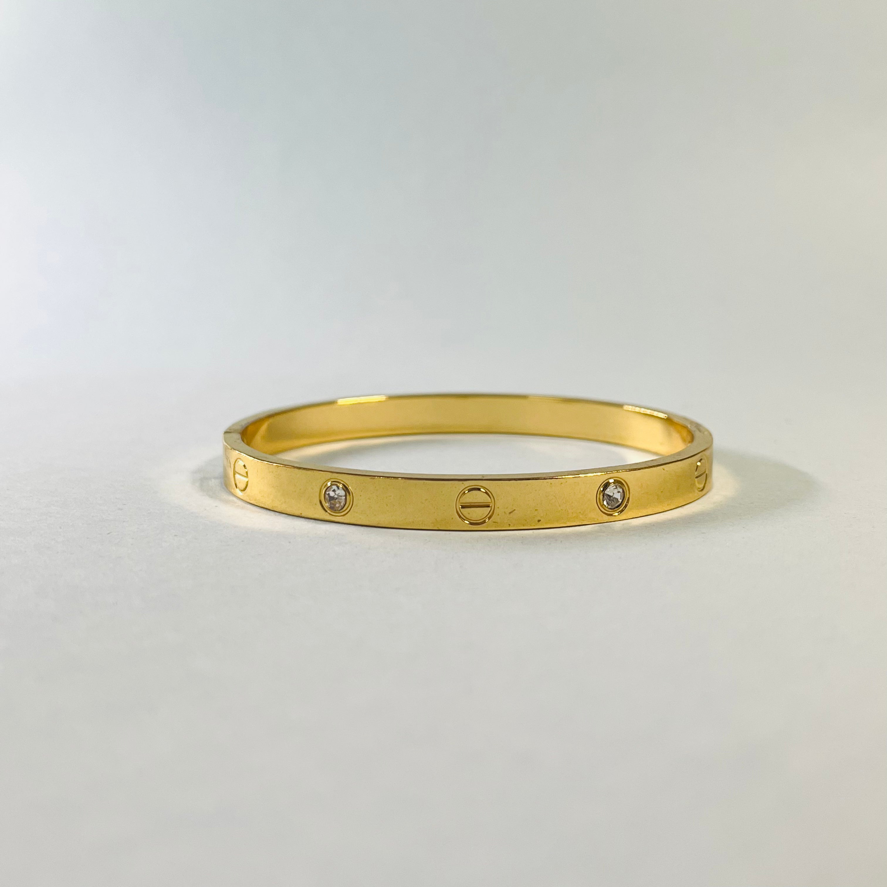 Radiant Gold-Tone Screw Motif Bracelet with Sparkling Stones