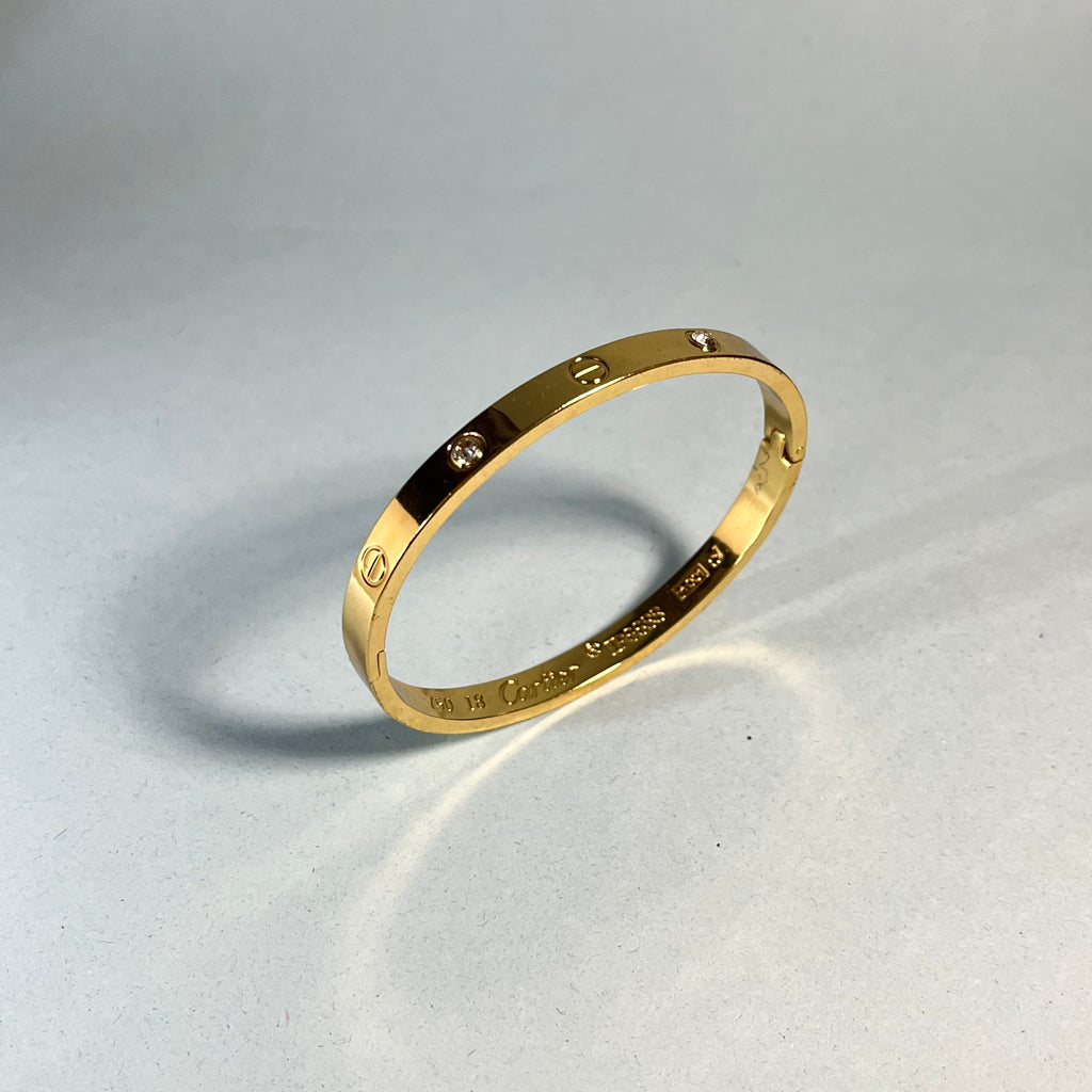 Radiant Gold-Tone Screw Motif Bracelet with Sparkling Stones