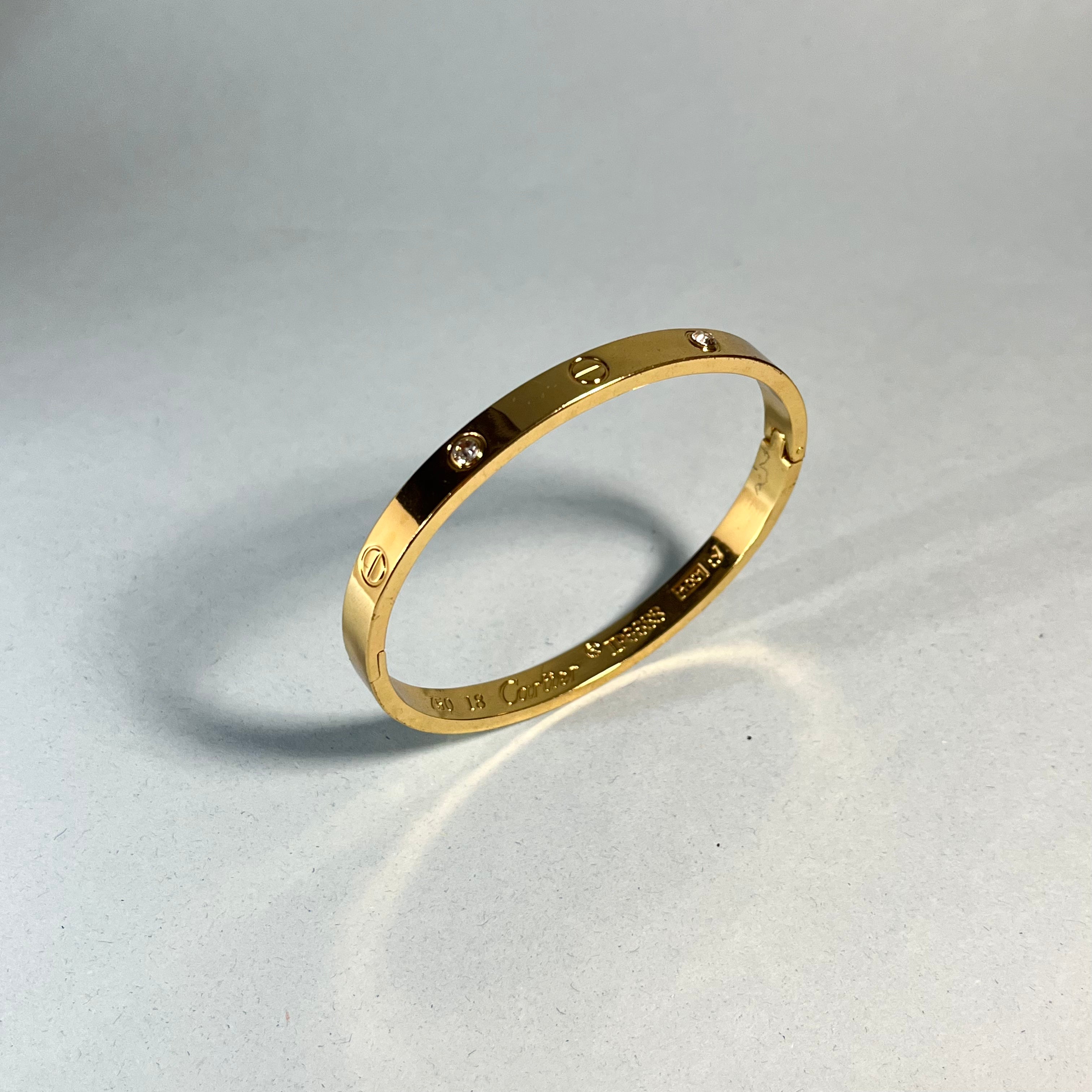 Radiant Gold-Tone Screw Motif Bracelet with Sparkling Stones