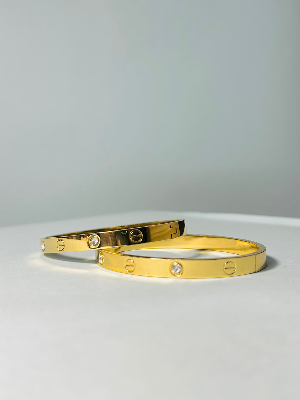 Radiant Gold-Tone Screw Motif Bracelet with Sparkling Stones