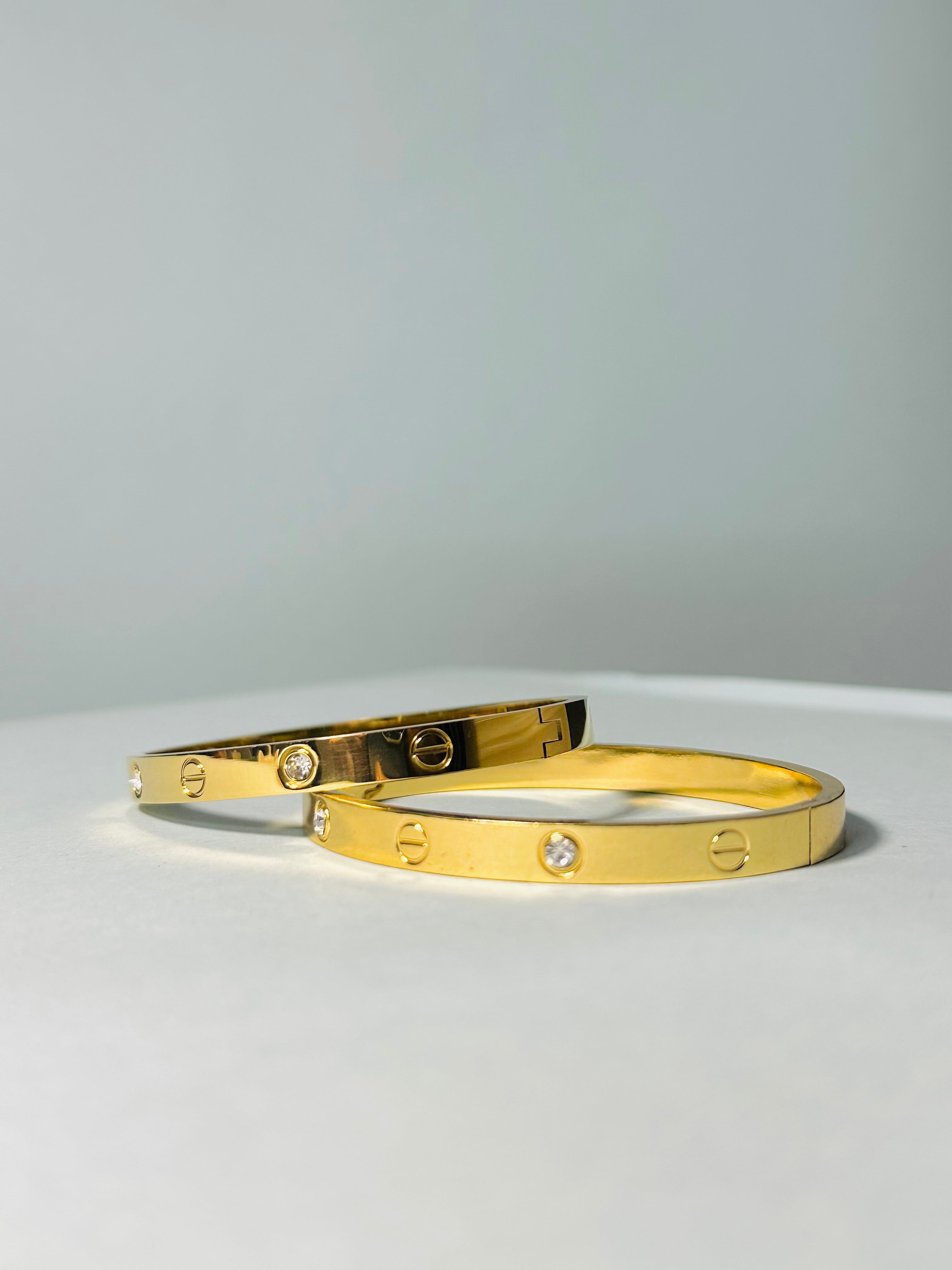 Radiant Gold-Tone Screw Motif Bracelet with Sparkling Stones