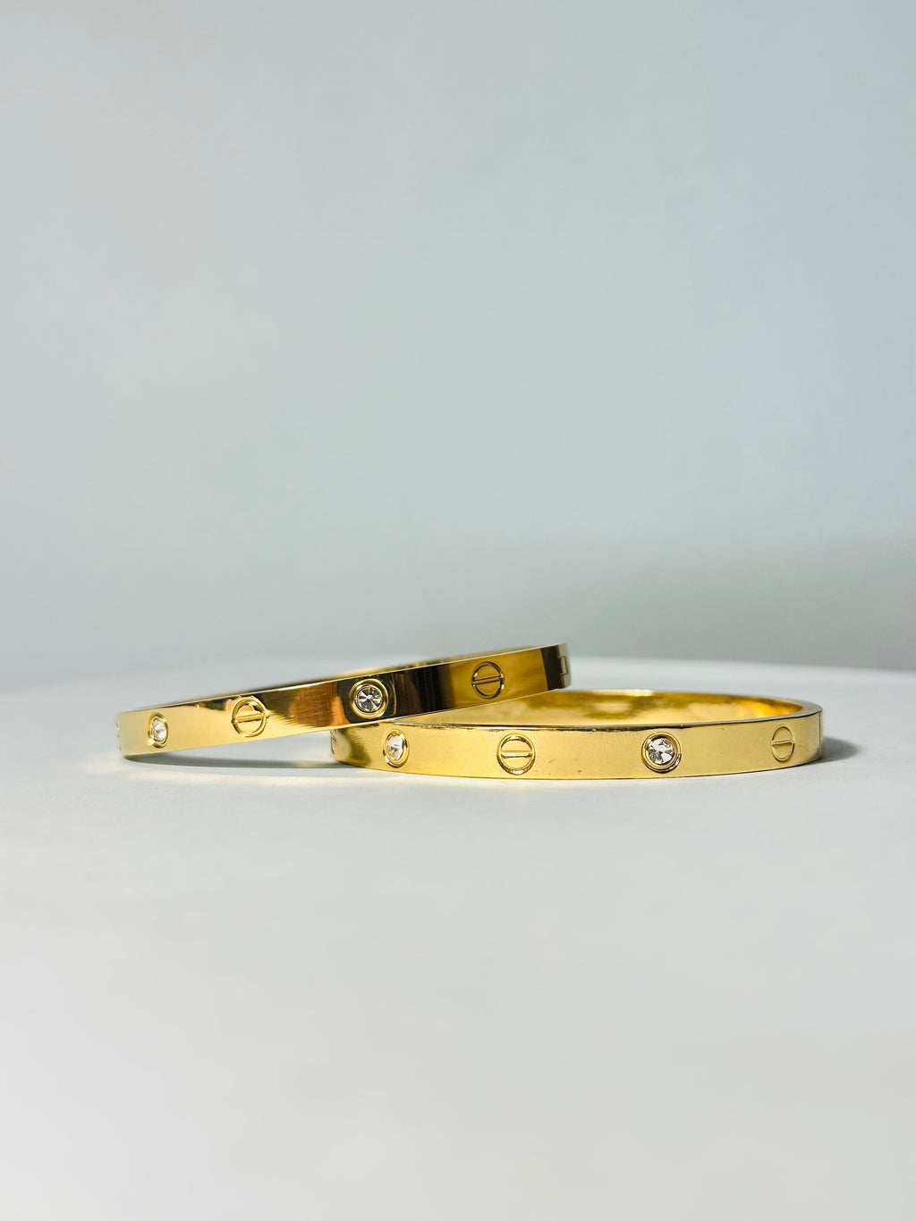 Radiant Gold-Tone Screw Motif Bracelet with Sparkling Stones