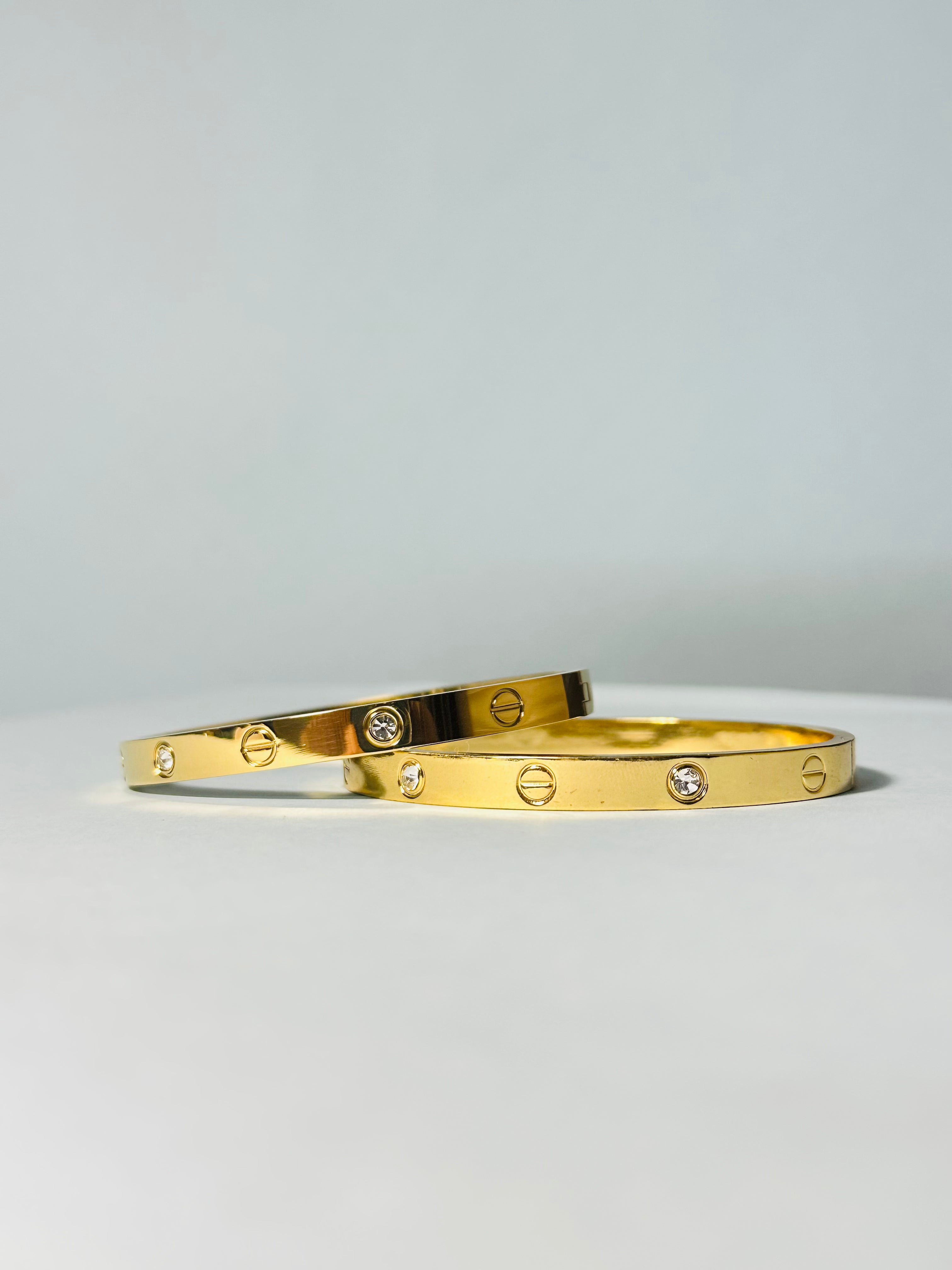 Radiant Gold-Tone Screw Motif Bracelet with Sparkling Stones