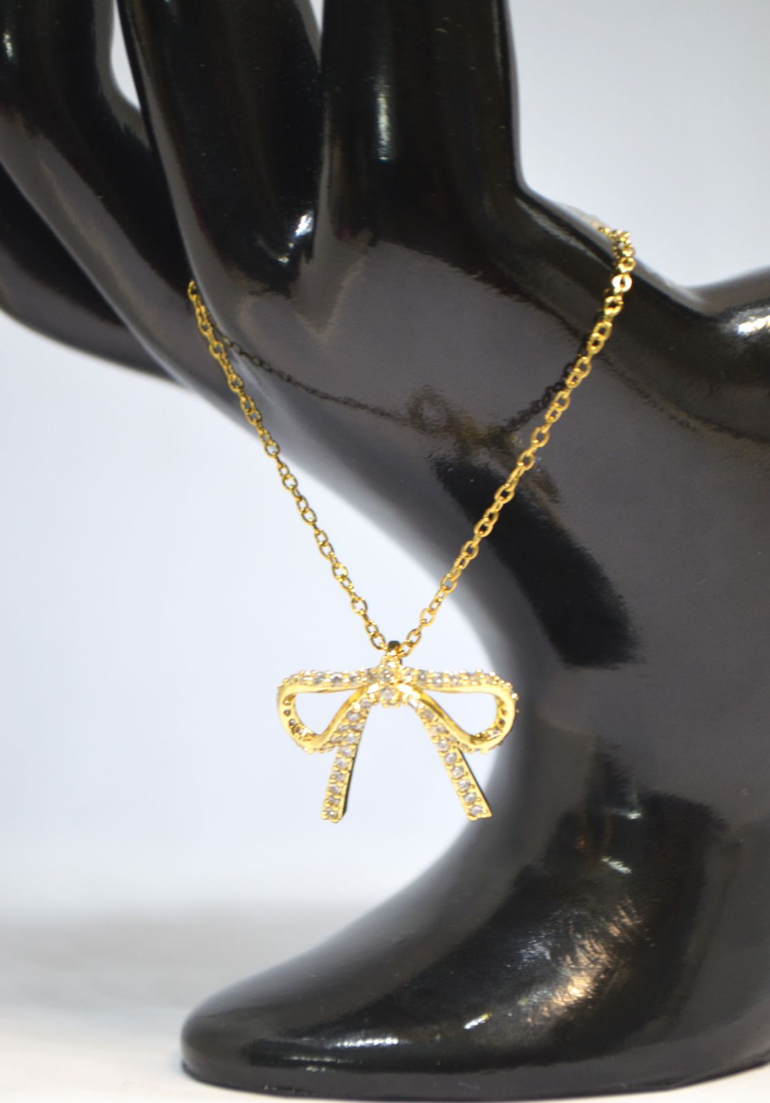 Dazzling Gold Bow Pendant Necklace with Crystal Detailing