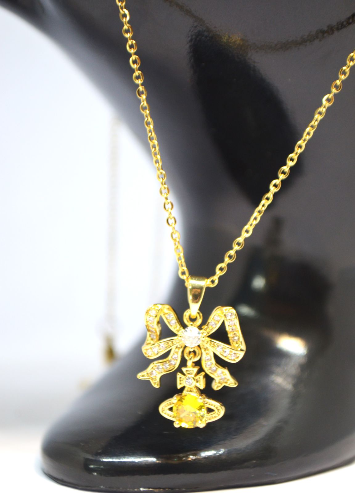Radiant Gold Bow Pendant Necklace with Yellow Gemstone Accent